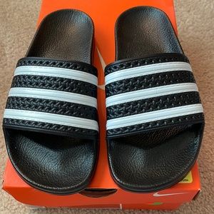 BRAND NEW, NEVER WORN, “ADDIAS” BRAND BLACK/WHITE/CORE BLACK TRADITIONAL SLIDES